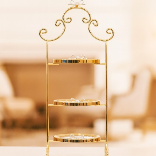 Izzhaar gold-toned 3-tier stand with delicate bow accents, perfect for sweets, gifting displays, or décor styling.